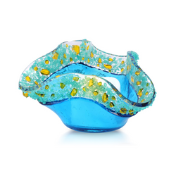 Turquoise glass votive with yellow and turquoise glass specks around the rim